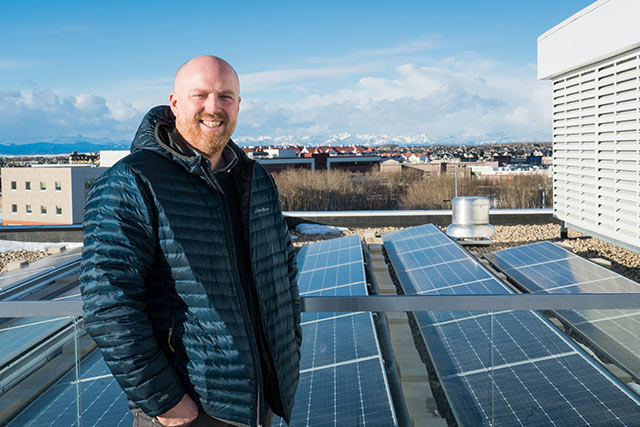 Danny on the roof with solar panels